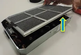 The filter sliding into the fan tray channel from above.